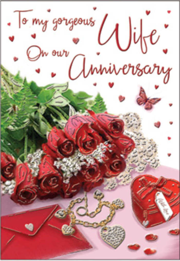 A warm, emotive anniversary tableau stretches across this image, reminiscent of a thoughtful gift laid out before a celebratory dinner in Southfields. At its heart is a bouquet of traditional red roses, each bloom open and full, petals layered in sumptuous spirals that radiate a deep, reassuring crimson. The roses are gathered with lush green foliage that arcs around them, adding softness and framing the flowers much like the greenery lining the residential streets off Replingham Road. Resting close by is an elegant anniversary card and its accompanying envelope, their creamy surfaces brushed with the soft reflection of nearby light. Alongside them, a vivid red gift box suggests a cherished piece of jewellery nestled inside, its surface smooth and gently reflective. A jewellery set is arranged with care, catching highlights of warm gold and cool sparkle as though just taken from its box to be admired. Subtle lace-like patterns and delicate heart motifs run through the composition, peeking from beneath the flowers and gifts, like the finishing touches added to a lovingly wrapped present at home in Southfields. The lighting is gentle yet purposeful, pooling on the roses, skimming the edges of the metallic elements, and casting faint shadows that add depth to each object. The overall atmosphere is unmistakably romantic but also grounded and genuine, echoing the quiet, enduring connections built over years together. Every detail, from the curve of each petal to the angle of the card, contributes to a scene that honours anniversaries as moments to pause, reflect, and celebrate a love that has grown stronger in the heart of Southfields.