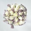 This bouquet captures the calm refinement that characterizes Southfields-a moment of morning tranquility transformed into flowers. At its heart, plush white roses, each blossom chic and perfectly layered, unfurl in soft, creamy spirals, echoing themes of beginnings and trust. Interwoven are delicate sprays of pale lavender statice, the dainty, lace-like blooms providing texture and gentle color. Set against a clean white backdrop, the arrangement nearly glows under gentle daylight, much like sunlight streaming through local gardens off Wimbledon Park Road. Subtle green accents lend a grounding freshness, giving the bouquet structure without overpowering its natural lightness. The composition is both comforting and uplifting-tailored for soothing difficult moments, sharing heartfelt congratulations, or brightening a friend's day nearby. The thoughtful spiral of every stem and the gentle scent that hovers in the air are a testament to local florist expertise and the sophisticated simplicity Southfields is known for, bringing lasting peace and grace with each delivery.